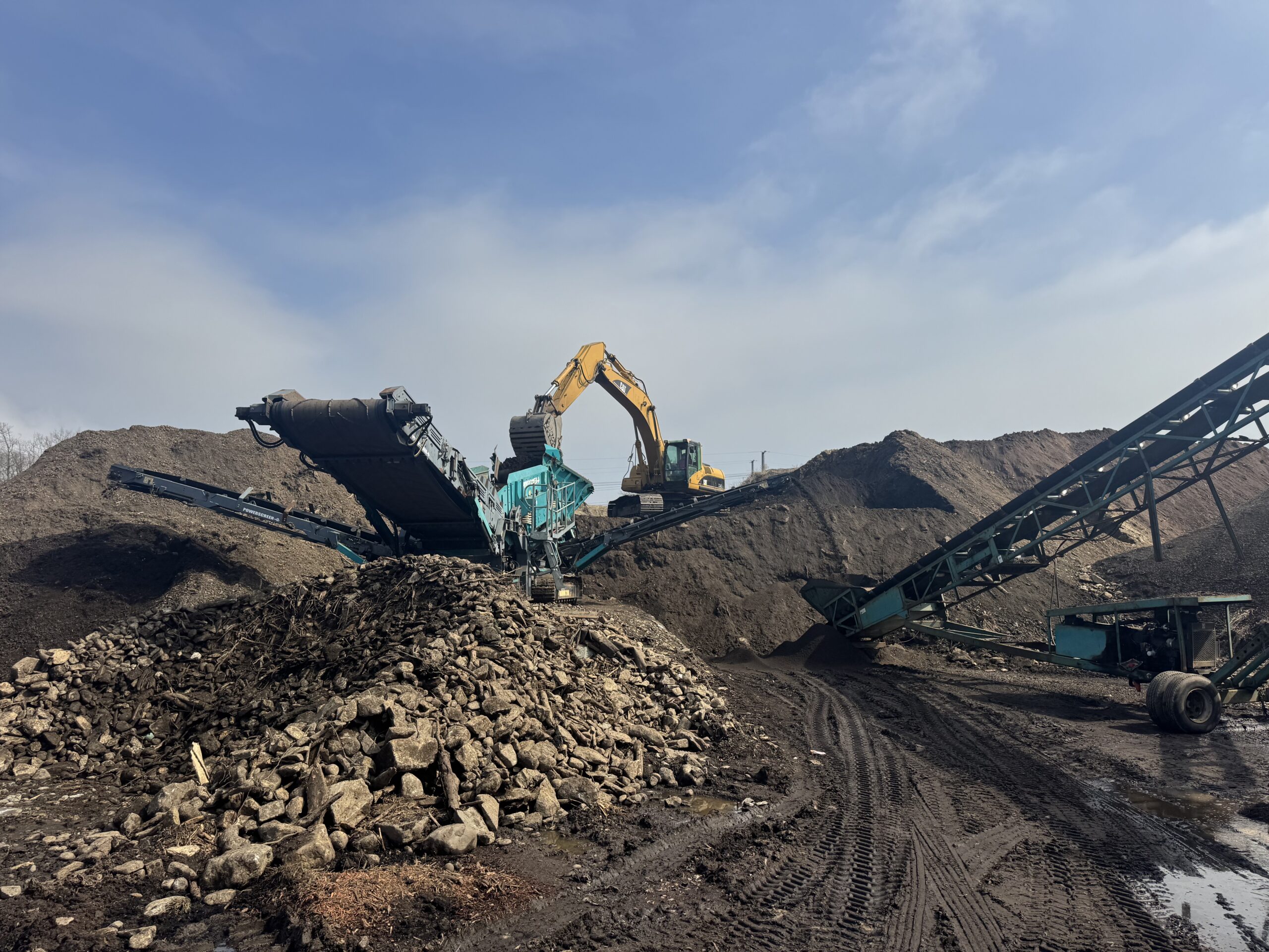 Topsoil screening operation with excavator and screening plant at Grillo Services Milford CT